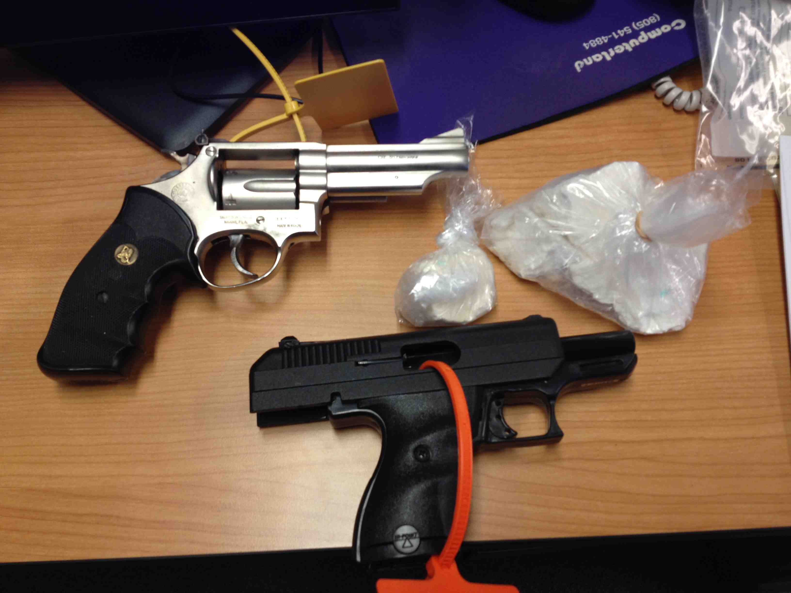 Two guns and two kids taken in cocaine bust