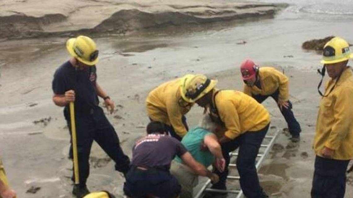 Woman and firefighters stuck in quicksand at a Santa Barbara beach